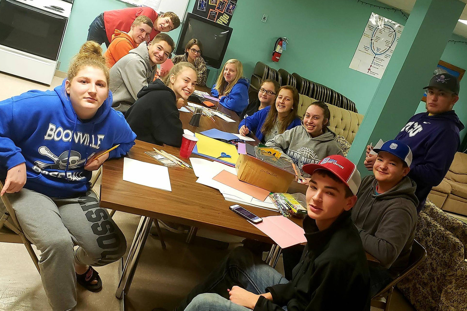 Members of the “Juvies for Jesus” high school youth group at Ss. Peter & Paul parish in Boonville make Christmas cards to send to the diocese’s seminarians in this December 2018 photo.